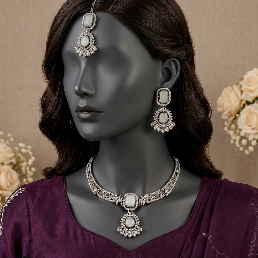 Gul-e-Mehraab S-79 grey and silver necklace set with matching earrings and maang tikka on a charcoal mannequin
