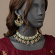 Gulband Emerald Green choker set on a mannequin in burgundy silk formalwear